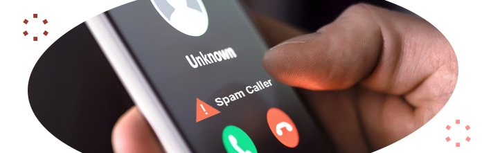 close up of hand holding a cell phone with unknown as the caller idea and a caution sign followed by spam caller