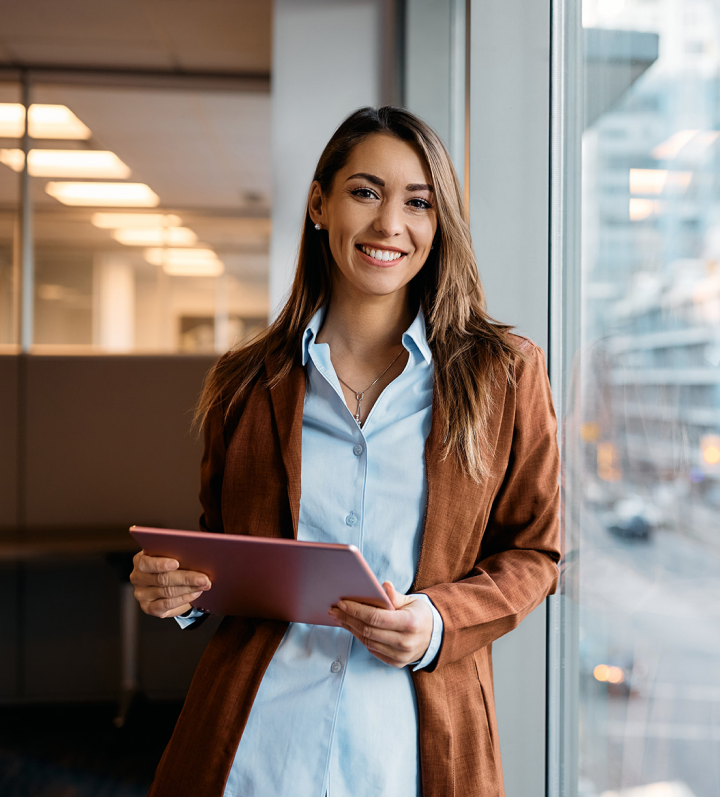 woman smiling holding a tablet