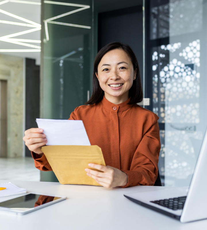 woman smiling and holding a document