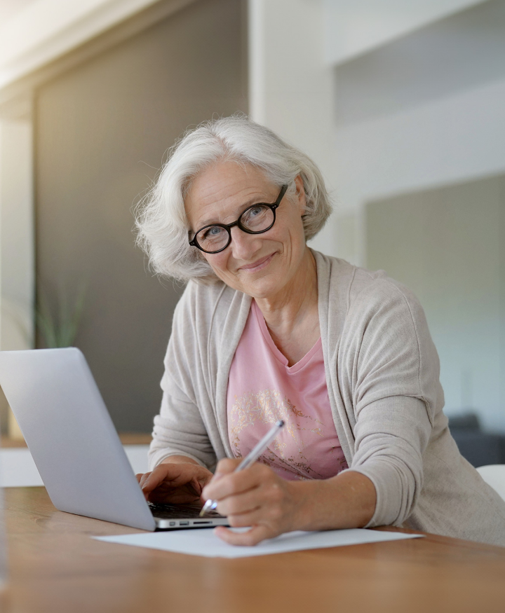 woman smiling and writing