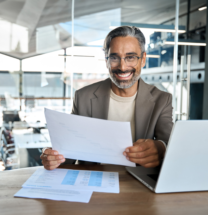 man smiling holding a document