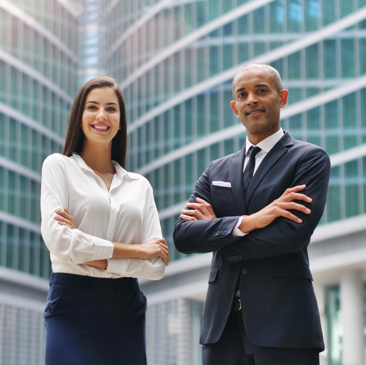 two people smiling with folded arms