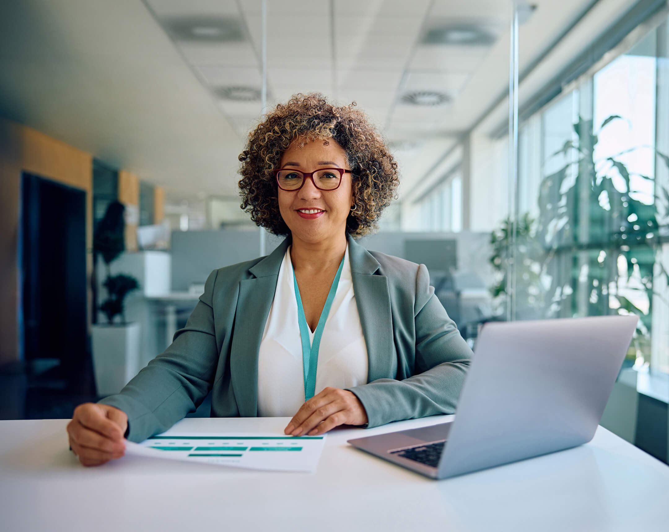 woman smiling with laptop and document