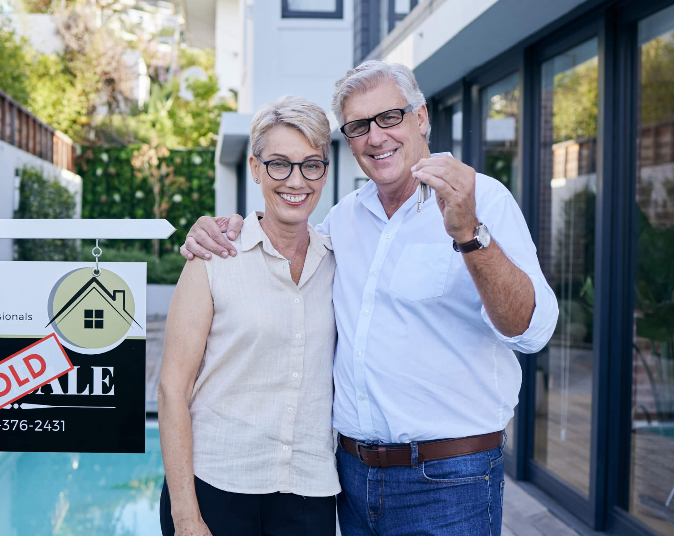 couple holding keys to new house