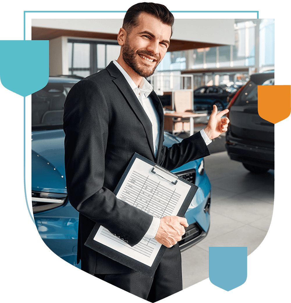 man at car dealership holding a clipboard