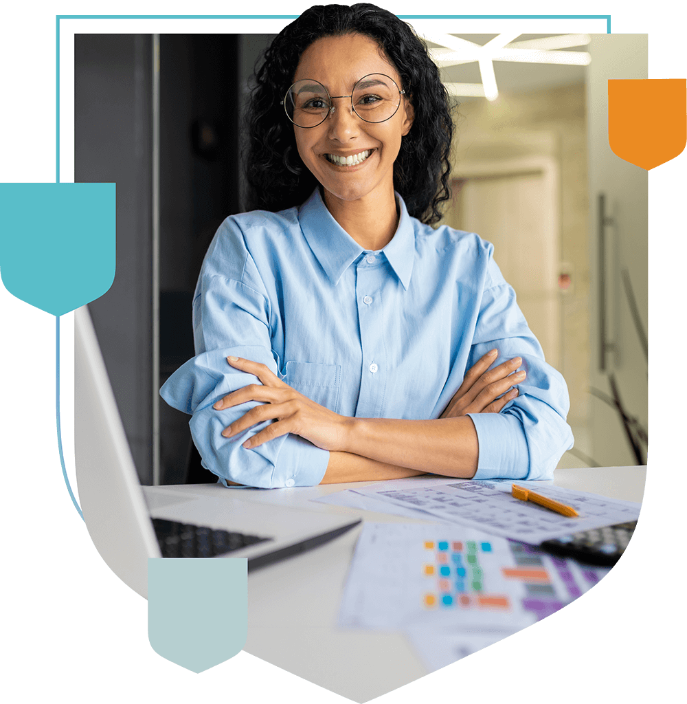 woman smiling at desk with laptop and documents