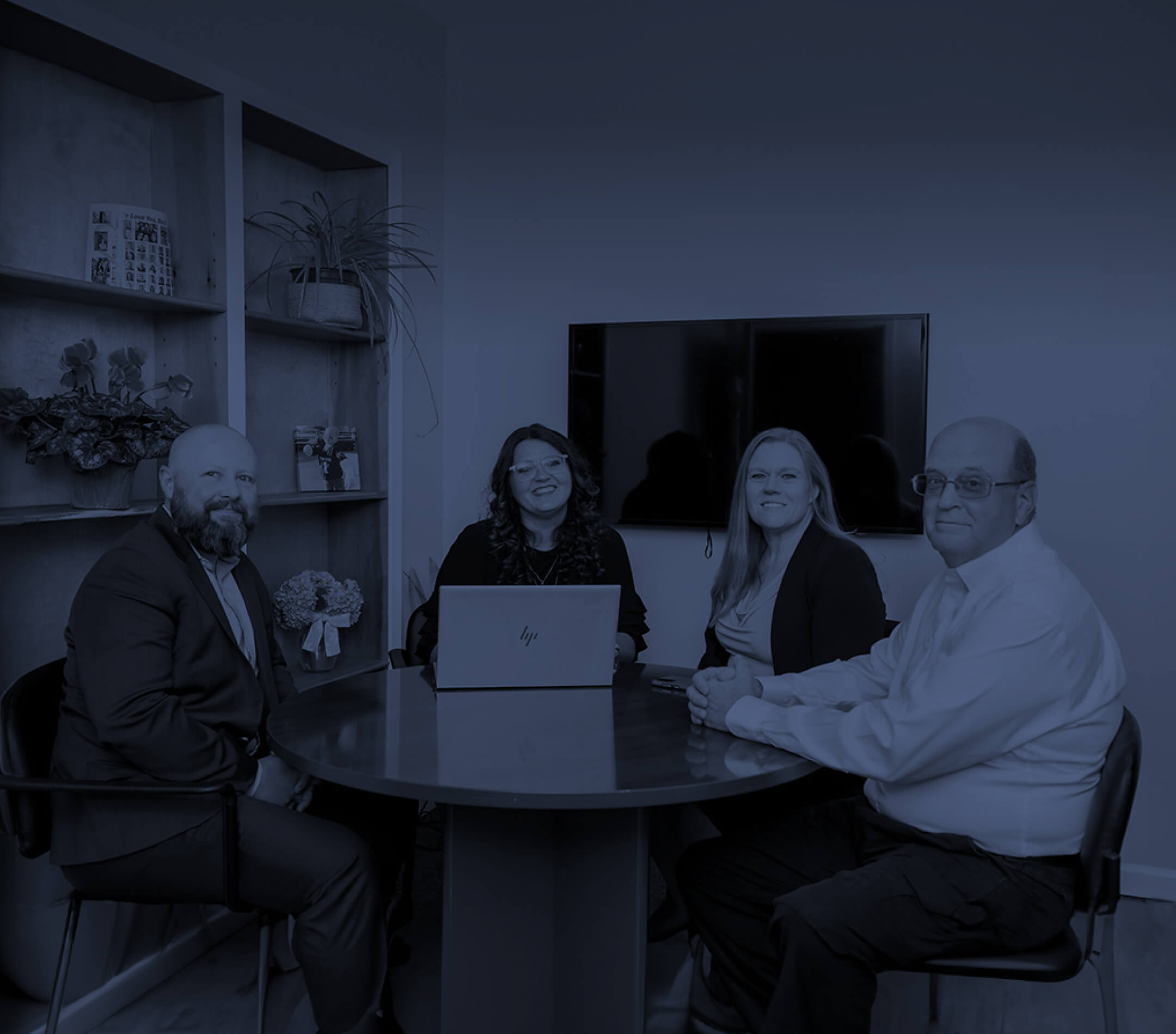 four professionals sitting around a table