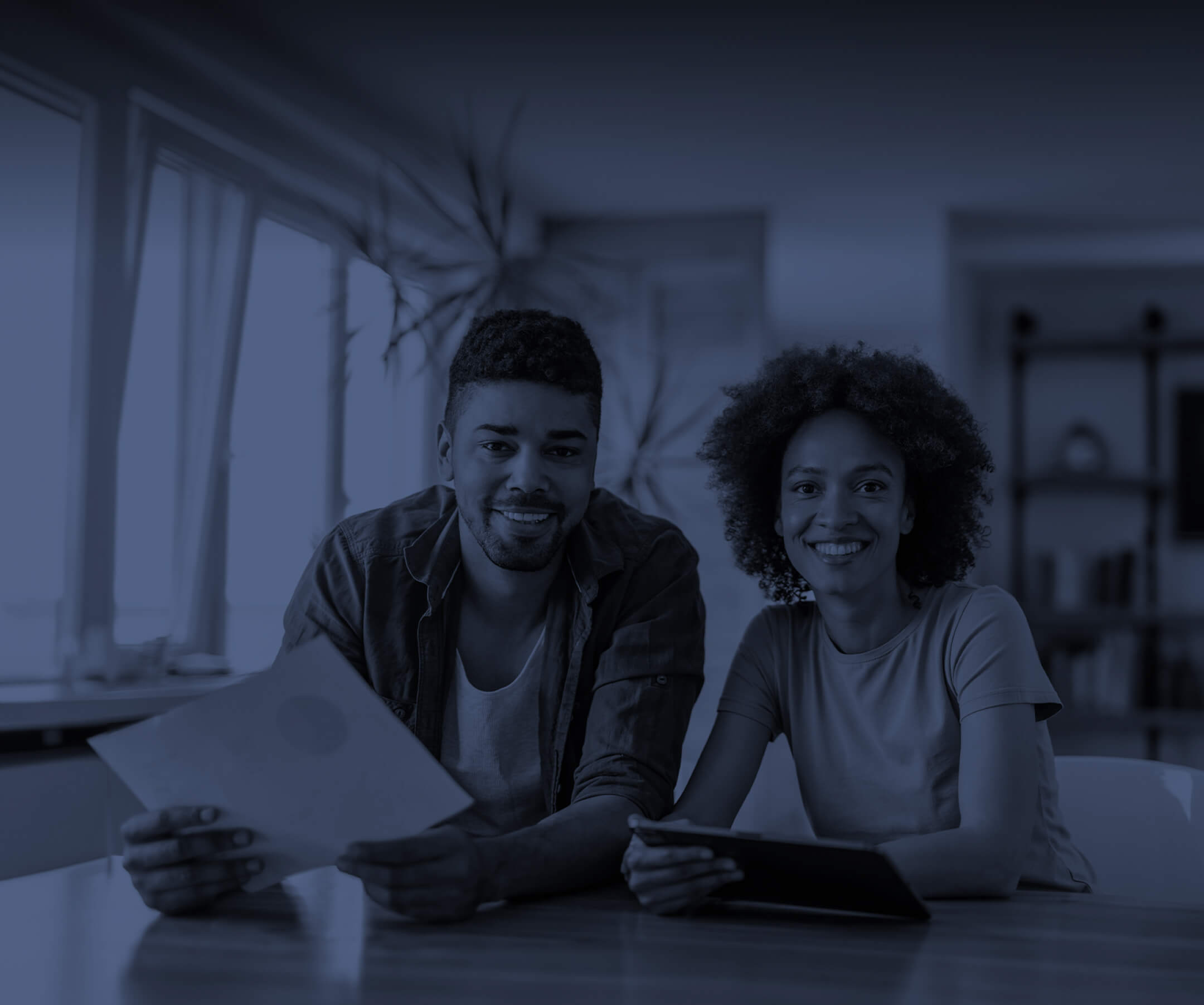 Two people holding documents and smiling